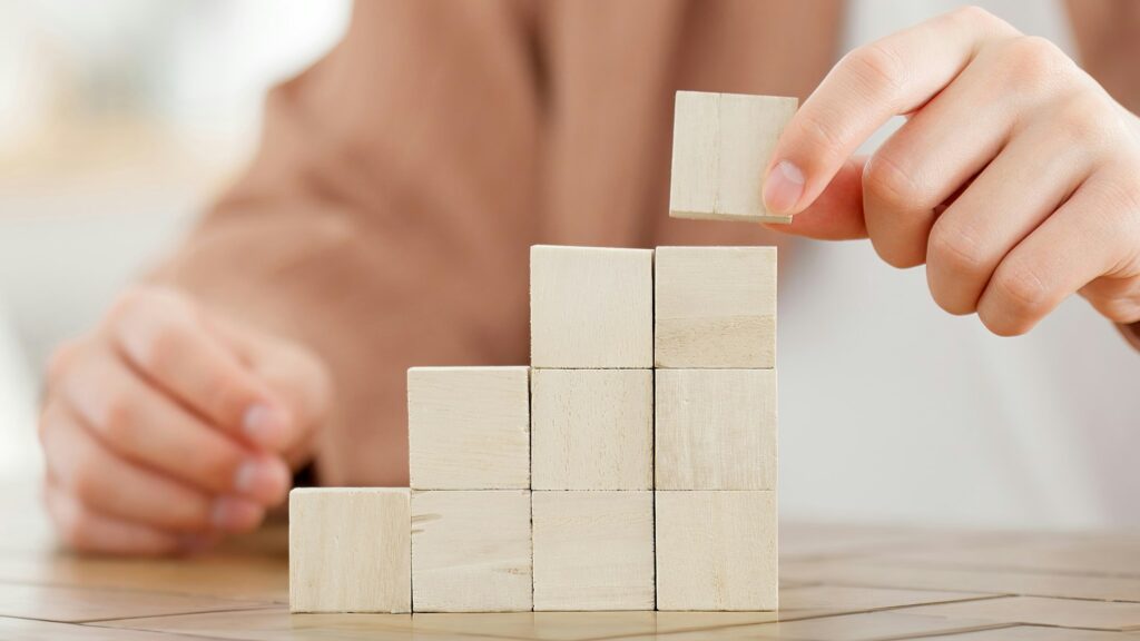 A man stacking building blocks